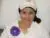 Woman in hospital bed wearing a cap and shirt.