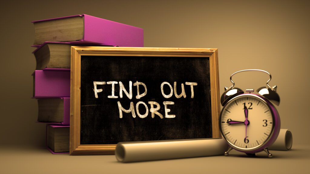Chalkboard reading 'FIND OUT MORE' with clock and books nearby.