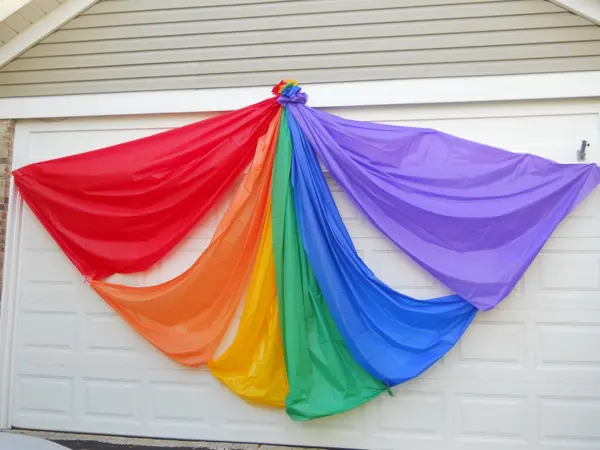 Colorful rainbow fabric draped on a wall.