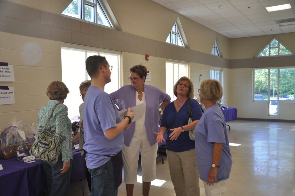 Healthcare professionals engaged in conversation inside a medical facility.