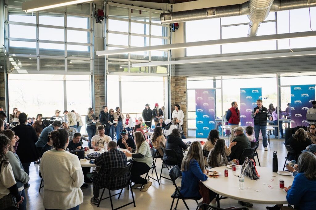 People gathered in a bright, modern room for a meeting or event.