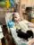 A child and a dog share a cozy, affectionate moment on a couch.
